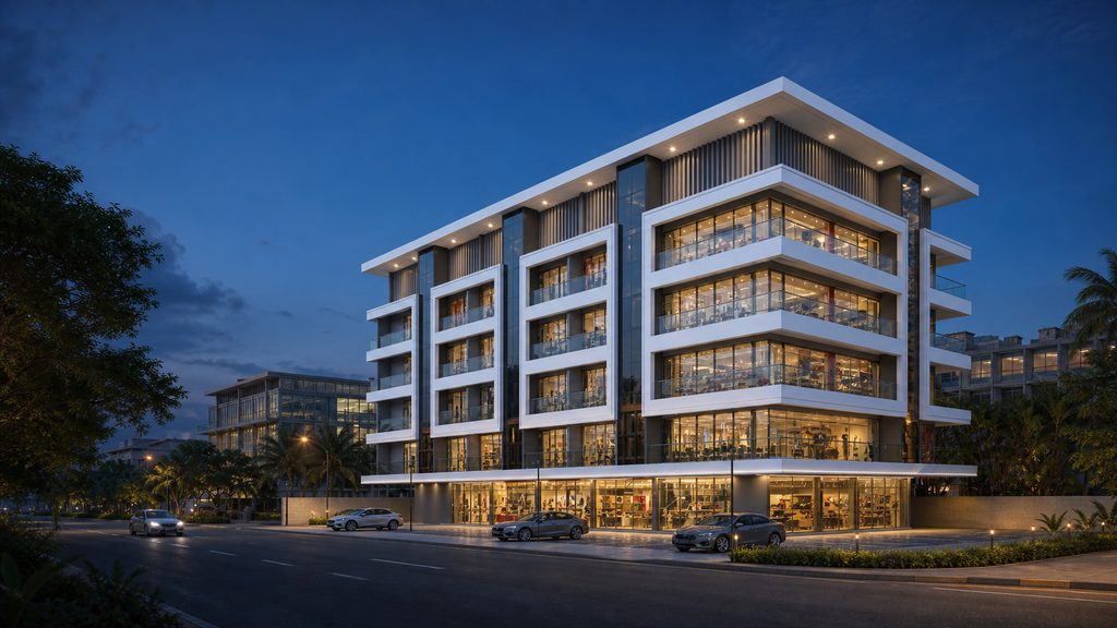 Bhandary Iniha Business Centre commercial building at Alake, Mangalore, lit at dusk with white facade frames and glass frontage
